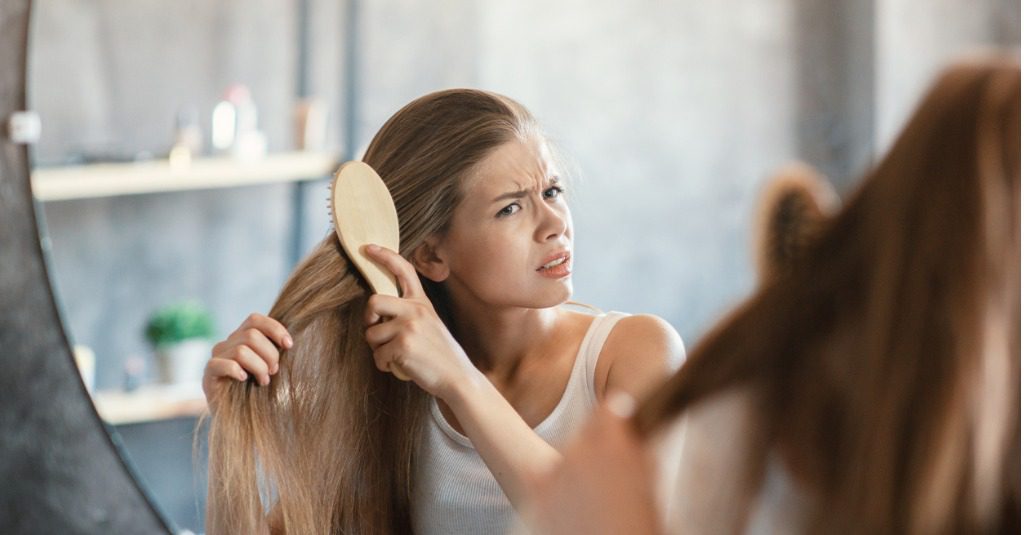 dry brittle hair woman brushing hair Copy